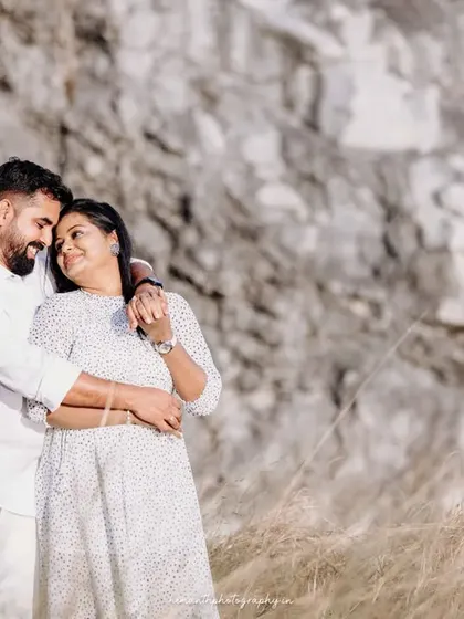 A joyful and candid shot of the couple sharing a laugh during their outdoor maternity session. Capturing these natural interactions is a key part of my photography style.