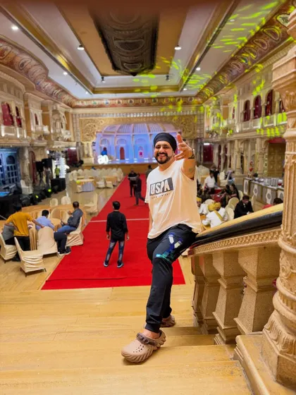 Taking a moment on the stairs of the grand venue after setting up for a 60th birthday party. The scale of the hall shows the kind of large private events I manage.