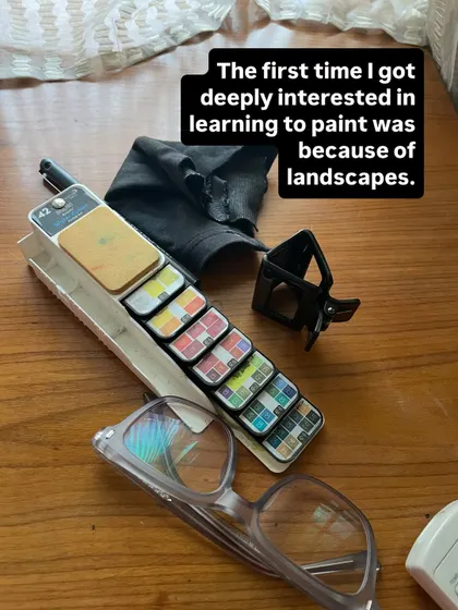 A glimpse of my art supplies. My portable palette, glasses, and a hair clip are always within reach when I'm creating.