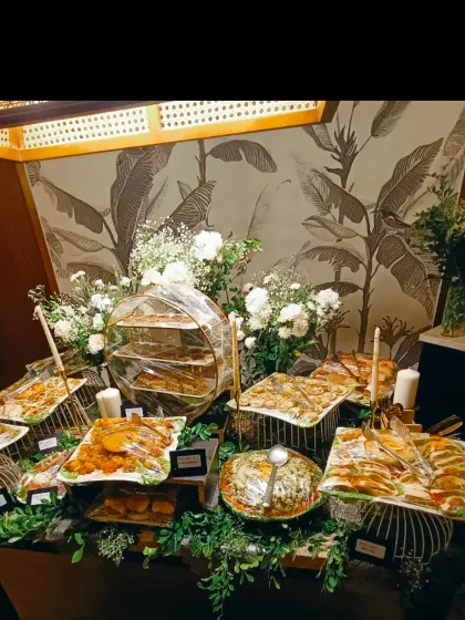 Flowers rise above our home grazing table, with customised canapés and little dishes arranged across stands at different heights.