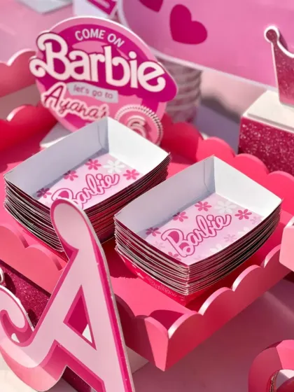 Custom-designed paper trays for serving snacks, all part of the cohesive Barbie theme.