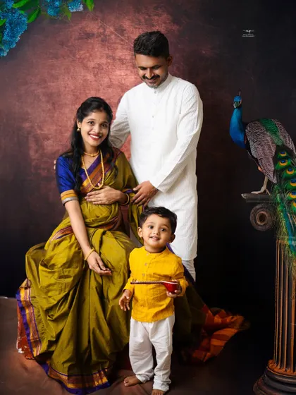A complete family portrait, full of warmth and tradition. The older brother stands proudly with his parents, creating a beautiful picture of a family waiting to welcome a new life.