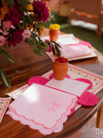 Custom table details from the 'Gulbahar' event, including personalized napkins and floral-shaped placemats. These small touches added to the bright and happy vibe.