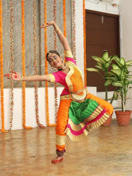A young Bharatanatyam dancer in a graceful pose.