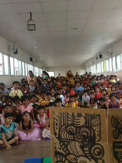 A wide shot of the audience during one of our school shows. The sheer number of happy faces is what motivates us.
