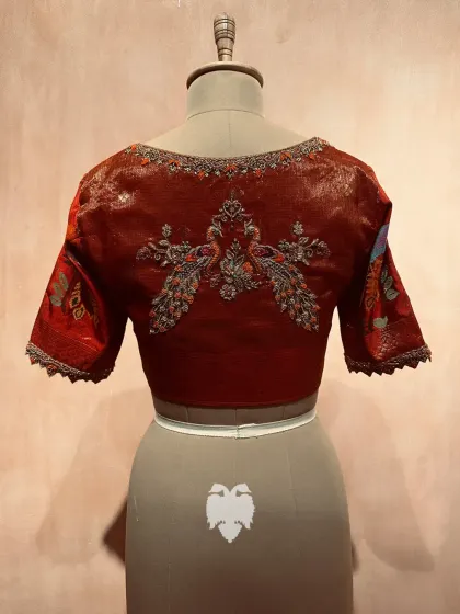 The back of the red zari kota blouse, featuring a symmetrical pair of peacocks.