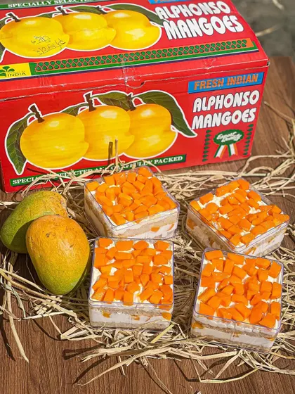 My fresh Alphonso mango cake tubs are a seasonal favorite, packed with layers of light cake, cream, and sweet mango chunks.