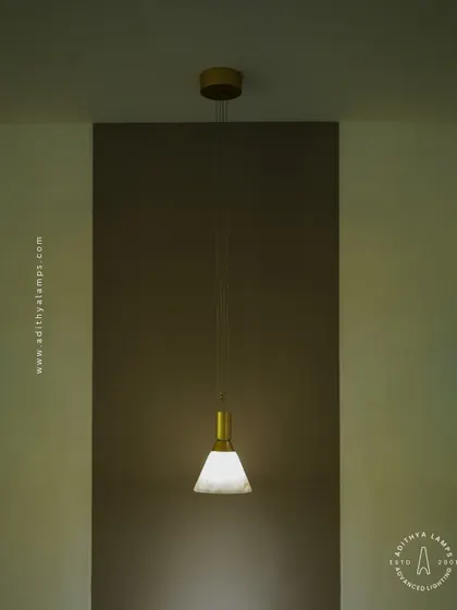 A simple yet elegant cone-shaped pendant light. The shade is crafted from marble, providing a warm, diffused downlight that is perfect for task lighting over kitchen counters, reading nooks, or as accent lighting.