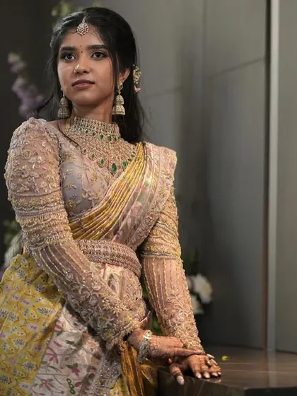 This client looks poised and elegant in her custom-designed outfit. The intricate embroidery on the blouse is a true work of art.