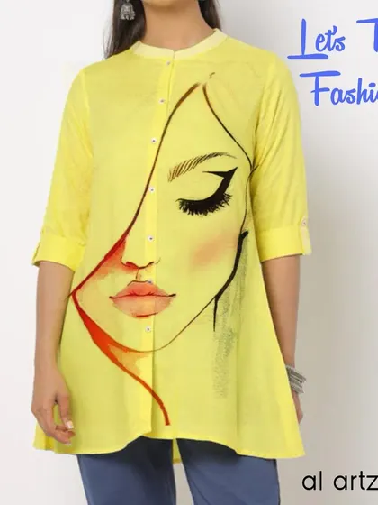 This yellow tunic features a minimalist, abstract face painted along the button placket. It's a stylish and subtle way to wear hand-painted fashion.