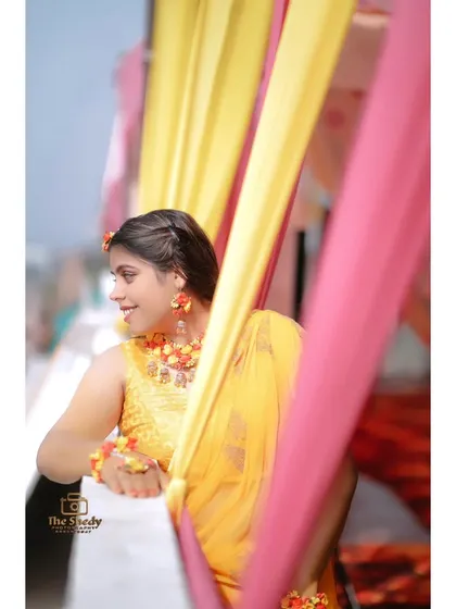 A happy, smiling portrait of Urvashi at her Haldi. We capture the genuine joy of the bride-to-be on her special day.