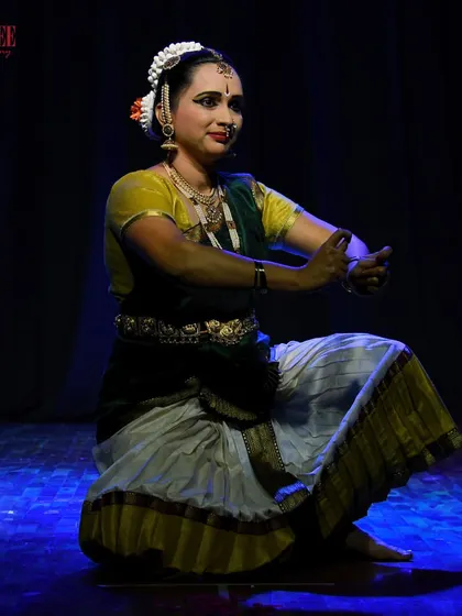 A student from our adult Bharatanatyam batch holding a pose with perfect form and expression during our Nritya Sanje performance.