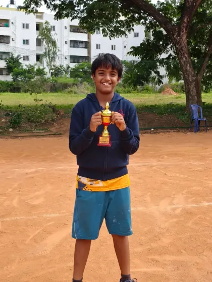 Amish, a finalist in the Under 12 category, smiling with his trophy. Every tournament is a learning experience, and reaching the finals is a significant milestone.