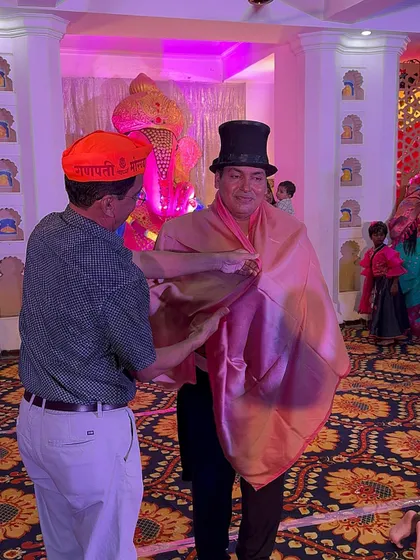 An organizer draping a shawl over me as a sign of respect and honor during the Ganesh Utsav festival. These moments of cultural appreciation are very special.