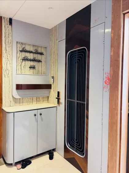 The complete foyer design, including a matching shoe cabinet and a custom nameplate panel, creating a fully integrated and stylish entrance.