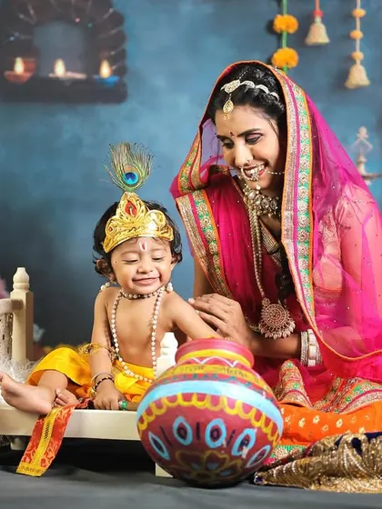 An emotional, candid shot of a mother consoling her crying "baby Krishna."