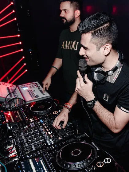 At the console, getting on the mic to connect with the crowd. This shot was taken before a weekend of back-to-back gigs in Indore.