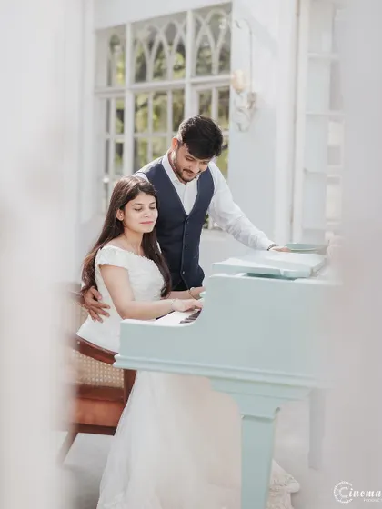 A sweet moment at the piano. This shot captures a shared activity, making the pre-wedding photo feel personal and reflective of the couple's interests.
