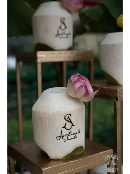 The personalized coconuts displayed on golden stands, turning a simple beverage station into an elegant feature. It's all about finding creative ways to make every part of the wedding special.