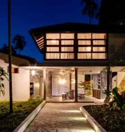 The entrance foyer of the main villa at Jalakara at night, its warm lighting creating an inviting welcome.