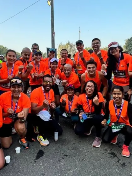 The tribe celebrating together after the Apollo Tyres New Delhi Marathon. The medals are a symbol of our collective effort.