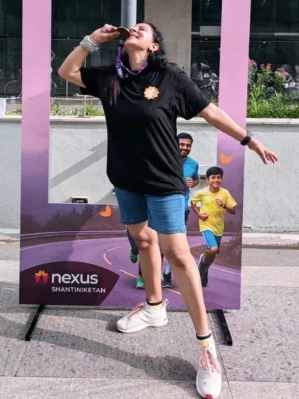A fun, celebratory moment biting my finisher medal after the "Run for Happiness" event. It’s not just about leading the warm-up; it's about being part of the entire experience.
