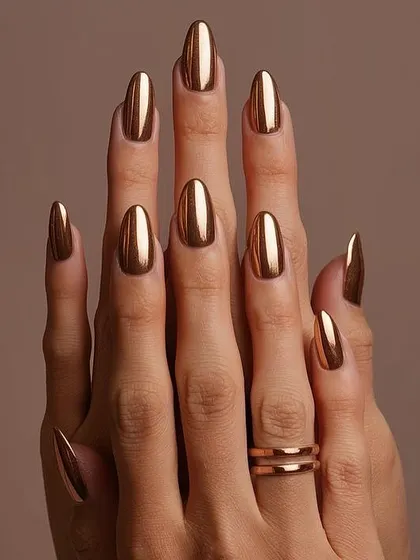 They call me the 'queen of bling' for a reason. This full set of almond-shaped chrome nails in a brilliant liquid gold finish is the ultimate statement in luxury. It's a bold, high-impact look that I love creating for clients who aren't afraid to stand out.