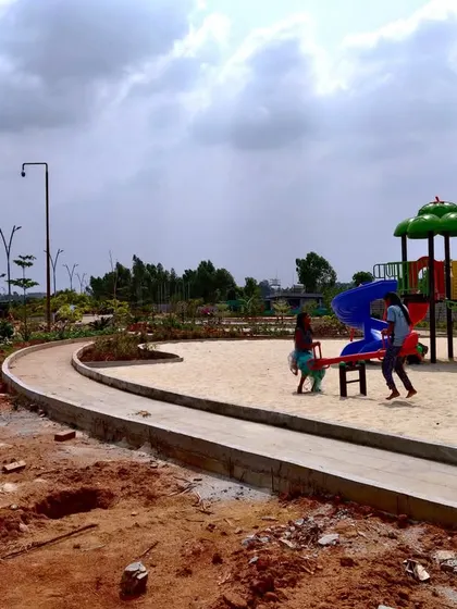 The children's play area at 'The Sanctuary' under construction, with the see-saw and slide already installed in the sand pit.