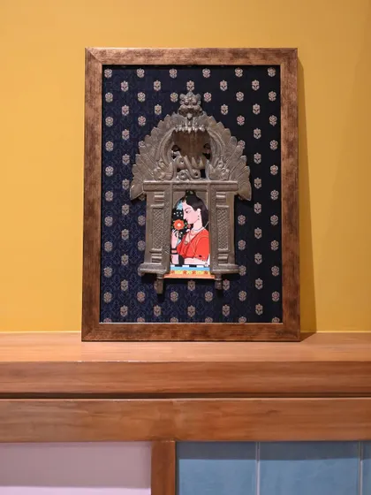 The framed Mughal miniature Prabhavali, a perfect example of how we can blend different art historical styles to create unique decor. The vintage brass frame adds a layer of history and character.