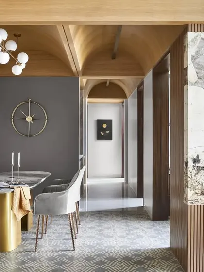 The vaulted wooden ceiling in this home is a key architectural feature that adds height, warmth, and character. It demonstrates how I work with a space's structure to create dramatic and inviting interiors.