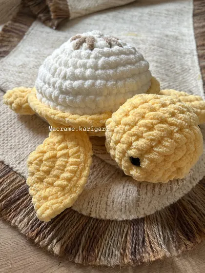 This is our lemon-themed turtle, with a bright white shell and a little brown detail on top. The cheerful yellow body makes it a sunny and happy addition to our fruit turtle family.
