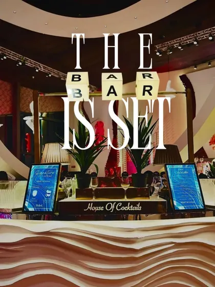 The bar is set and ready for action. This setup features a modern, wave-textured bar front, digital menu screens for easy ordering, and illuminated letter blocks that make a bold statement.