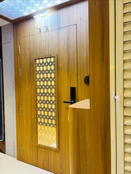 The entrance is illuminated by a backlit ceiling panel with a matching geometric pattern, tying the whole design together.