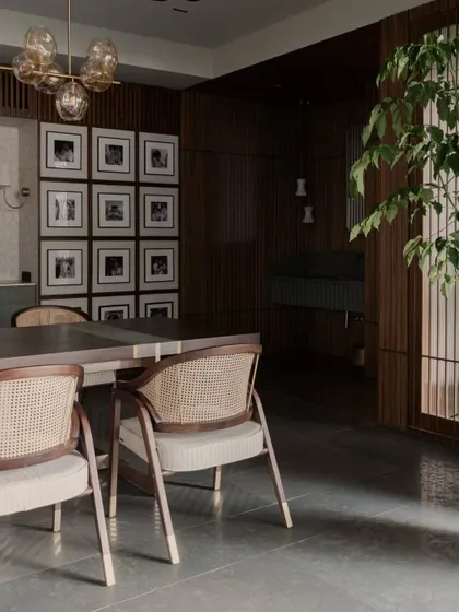 Another angle of the dining room, showing how the natural light from the side brings the space to life. The indoor plant adds a touch of green, echoing the home's connection to nature.
