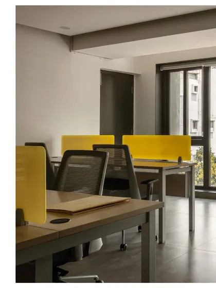 The minimalist office space is designed for functionality and focus. We used clean lines and simple materials, with pops of color in the desk dividers to add energy without creating visual clutter.