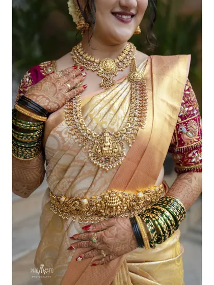 A close-up shot focusing on the bride's magnificent temple jewelry, a key part of the South Indian bridal look.