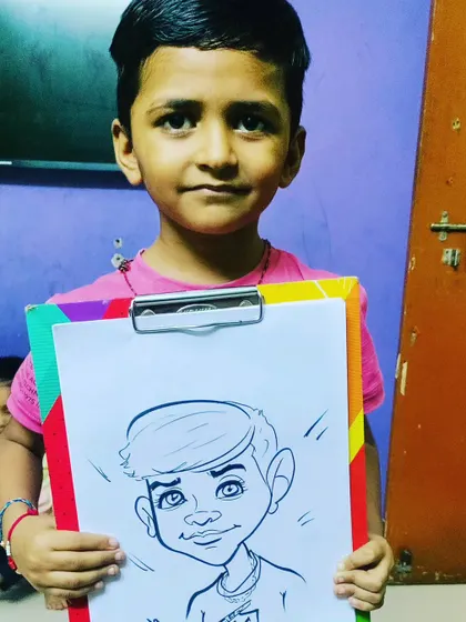 A close-up of a young boy proudly holding his caricature. I focus on capturing their happy expressions and unique features in my drawings.