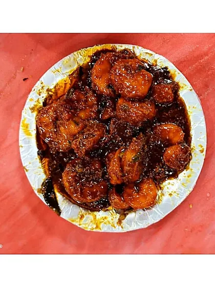 A plate of our delicious and spicy Chilly Prawns. The deep red colour of the sauce tells you it's packed with flavour, perfect for seafood lovers.