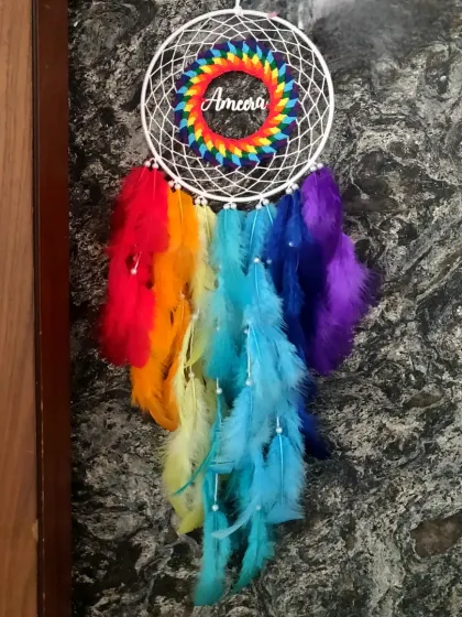 A rainbow of color to brighten any space. This personalized dreamcatcher features the name 'Ameera' and a full spectrum of vibrant feathers for a truly joyful wall hanging.