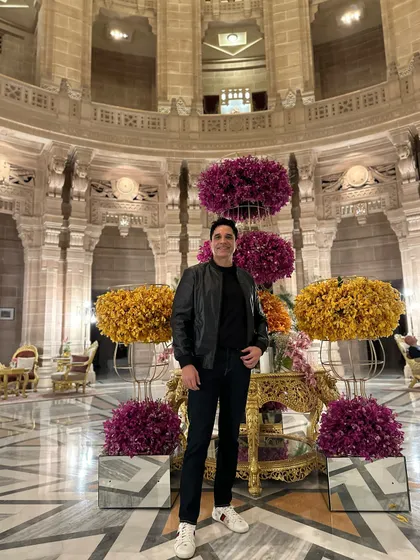 At the breathtaking Umaid Bhawan Palace in Jodhpur. The sheer scale and beauty of the central hall, adorned with floral decorations, make it one of the most spectacular wedding venues in the world.
