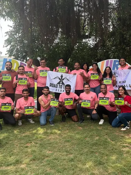 Another group of RTC runners, bibs in hand, ready to take on the TCS World 10K. The sea of pink shirts shows our club's strong presence.