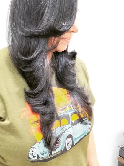 A beautiful example of a layered haircut with an outward blow-dry. This styling technique adds volume and creates soft, flowing layers that frame the face perfectly.