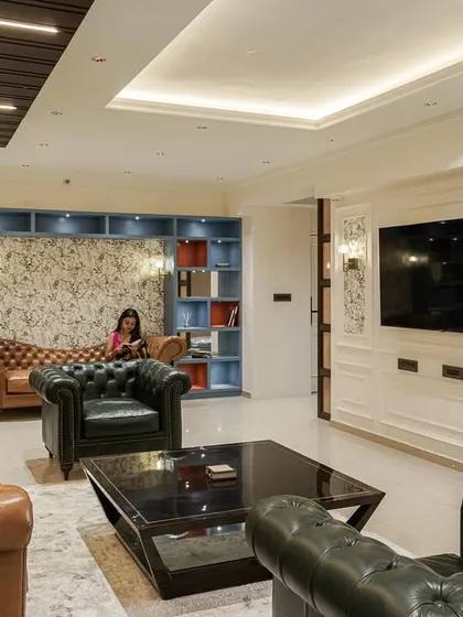 A wide shot of the living room from image 61, showing the full layout with the custom shelving and classic furniture.
