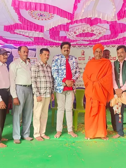 A group photo on a simple stage at a local function. No stage is too big or too small to spread laughter.
