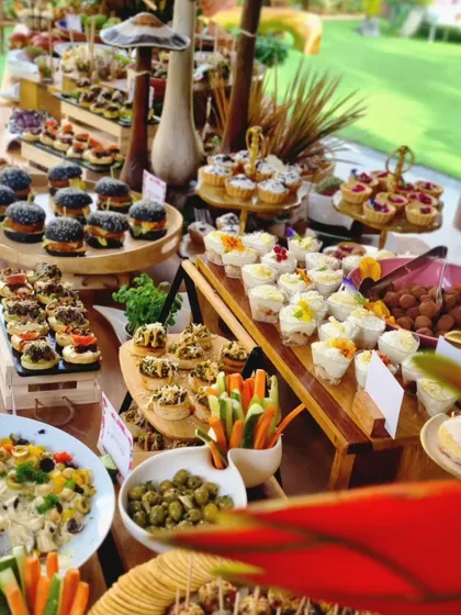 This vibrant spread showcases our black bun sliders, mini quiches, and dessert cups. The variety in color and form makes our grazing tables a focal point of any event.