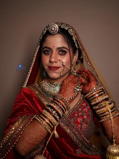 A confident bridal portrait where the bride is adjusting her earring, adding a touch of candidness to a posed shot.