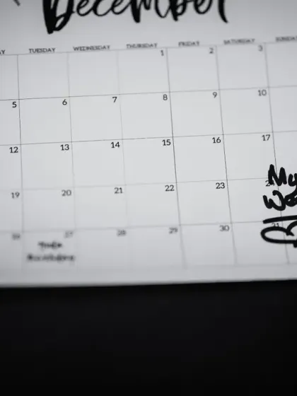 A detail shot of a calendar marking the wedding date, a simple yet powerful symbol of the most important day.