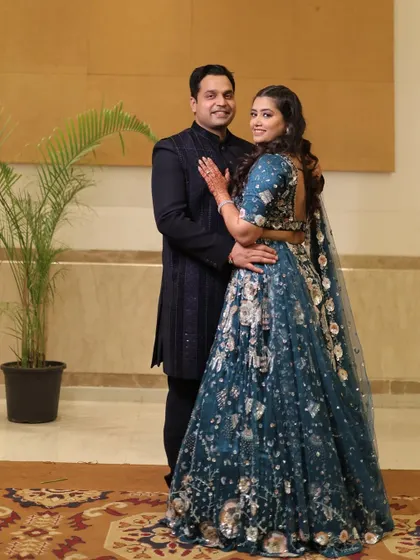 A classic portrait of a smiling couple at their sangeet. Our elegant decor provides a sophisticated backdrop that enhances their formal portraits.