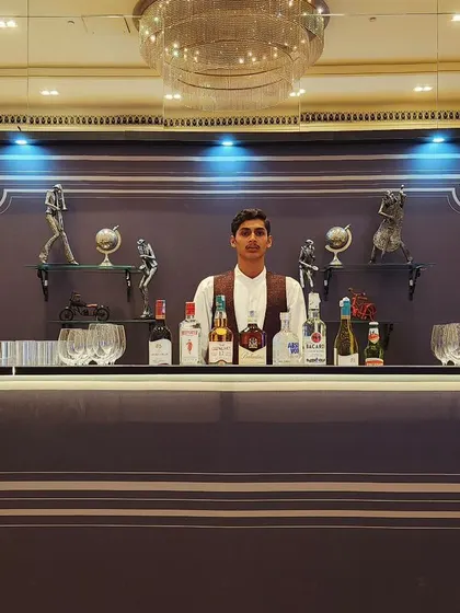 Our classic dark wood bar with elegant moulding and back-lit shelving provides a timeless, speakeasy feel. This setup is ideal for formal events, corporate functions, or any party aiming for a sophisticated, classic vibe.