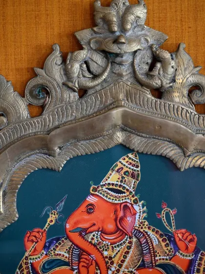 A close-up on the top of the Ganesha prabhavali, highlighting the antique craftsmanship of the arch itself, which I always aim to honor with my artwork.